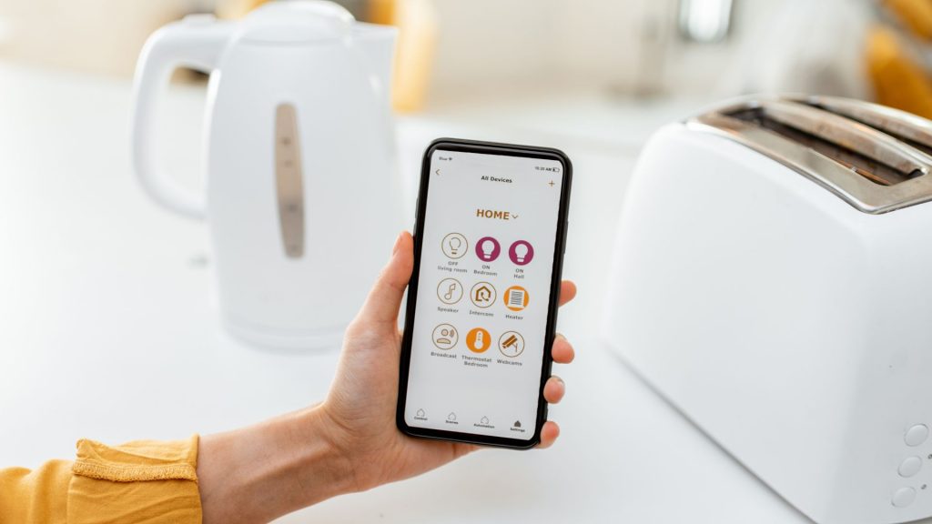 A homeowner uses an app to turn on smart appliances. 